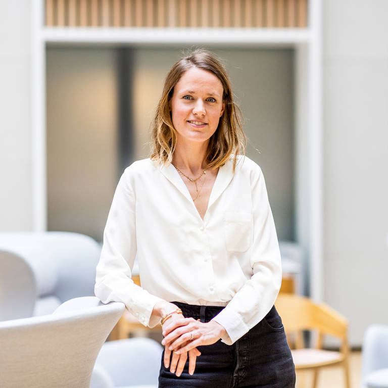 Female Lazard Colleague Smiling at Camera