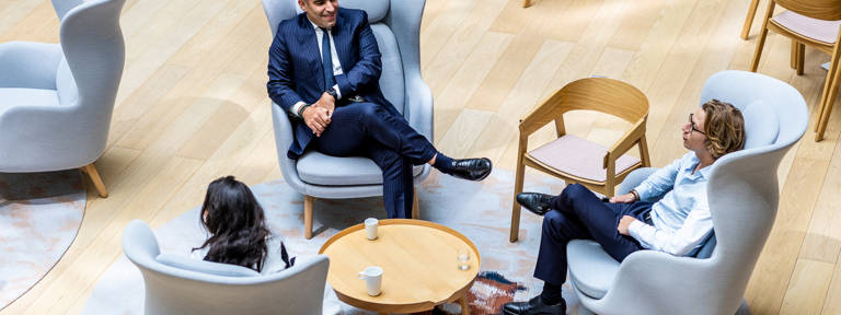 3 Lazard Colleagues in Paris Sitting in Armchairs Around Coffee Table