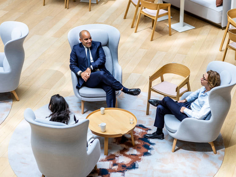 3 Lazard Colleagues in Paris Sitting in Armchairs Around Coffee Table